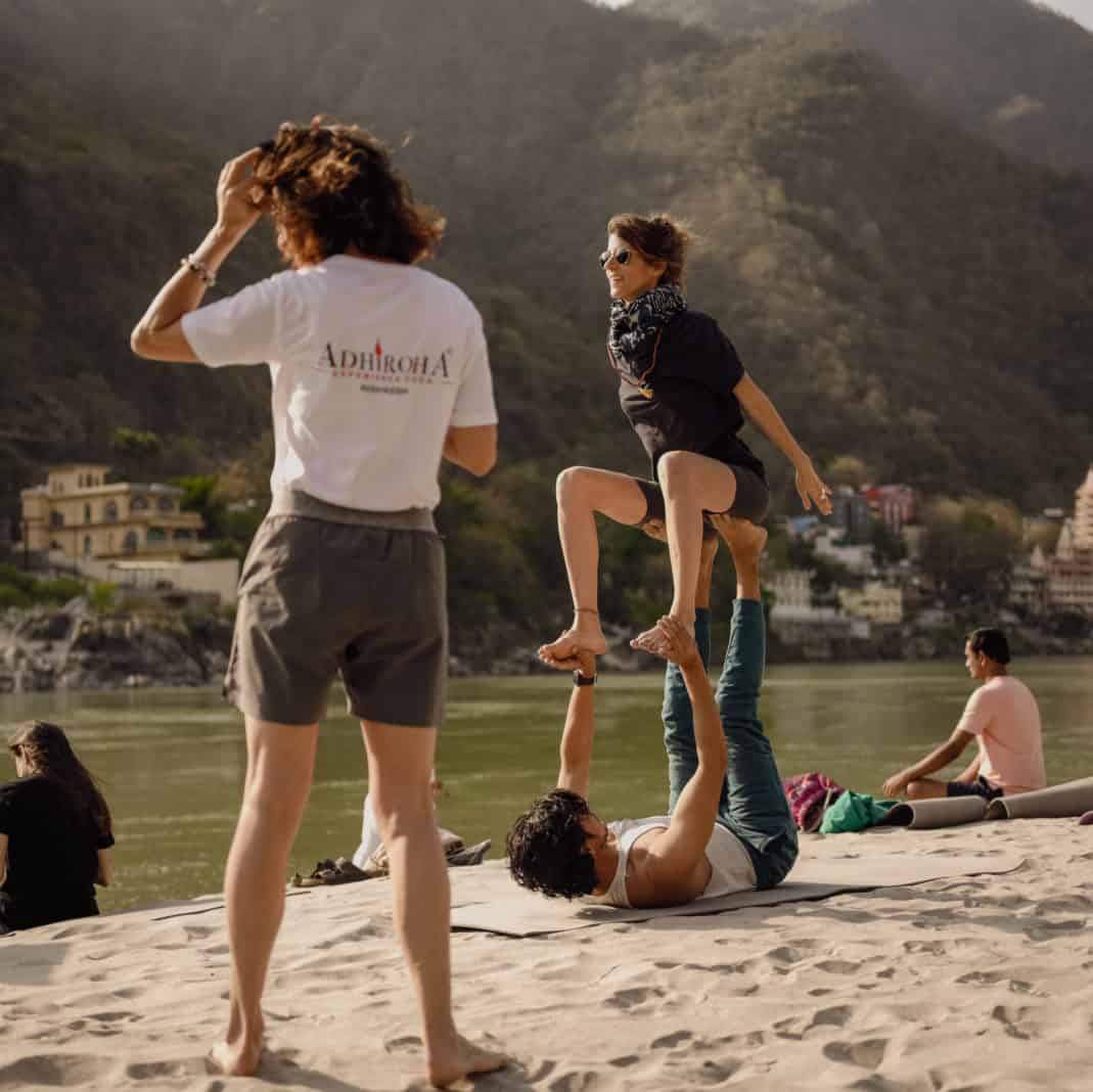 a group of people standing on top of a sandy beach